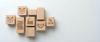 Wooden blocks with engraved retail and shopping icons including gift box, percentage sign, and tax symbol arranged on white background for business and commerce design projects.