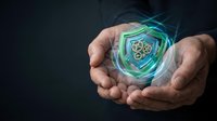 Hands holding glowing digital shield with gear icon, representing cybersecurity, data protection, and technology solutions for business and network safety.