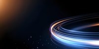 Glowing light trails curve across dark background creating dynamic motion effect with blue and orange streaks against starry space atmosphere.