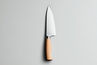 Professional chef knife with wooden handle on light gray background, minimalist kitchen utensil isolated for culinary and cooking design projects.