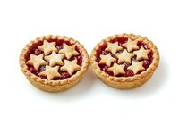 Two homemade fruit tarts with golden pastry crusts filled with red jam and topped with star-shaped cutout pastry pieces, isolated on white background for bakery, dessert, and food design projects.