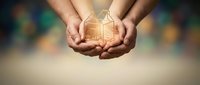 Hands holding glowing house model symbolizing home protection, real estate investment, property insurance and mortgage security concept.