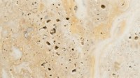 Beige travertine stone surface with natural pores and veining, suitable for interior design, architecture, and construction projects.