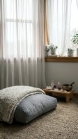 Cozy meditation corner with floor cushion, knitted blanket, crystals and plants by sunny window. Mindful living space for relaxation and wellness practices.