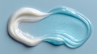 Smooth white and blue cosmetic cream swirl on light blue background, showcasing skincare product texture for beauty advertising.
