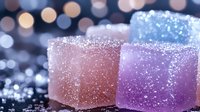 Colorful sugar-coated candy cubes with sparkling crystalline coating in pink, purple, and blue tones against blurred bokeh background for confectionery and dessert designs.