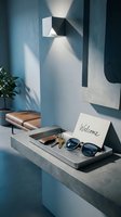 Modern entryway with concrete shelf, metal tray holding sunglasses, keys, wallet, and welcome card. Stylish wall lamp, blue tones, minimalist interior design.