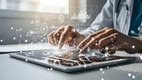 Healthcare professional using laptop with digital medical data analytics overlay for modern telemedicine and health technology solutions.