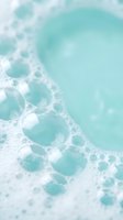 Turquoise ocean waves with white foam bubbles creating abstract aqua water texture for summer beach vacation backgrounds and coastal design projects.