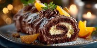 Chocolate yule log cake with cream filling and orange garnish on festive table with warm bokeh lights for holiday celebrations and Christmas desserts.