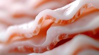 Raw bacon strips with marbled fat layers showing natural meat texture and patterns for culinary and food photography applications.