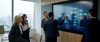 Corporate team collaborating at interactive digital display in modern office with city skyline view, suitable for business technology and teamwork concepts.