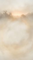 Misty morning landscape with golden sunrise breaking through fog over trees creating dreamy atmospheric scene with soft warm light and ethereal mood.