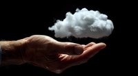 Male hand holding floating white cloud against black background, representing dreams, innovation, technology and environmental concepts for business presentations.