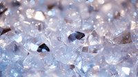 Sparkling clear crystal formations with faceted surfaces reflecting light, creating a luminous and ethereal macro view of mineral structures.