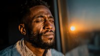 African American man with beard enjoying peaceful sunset moment with closed eyes and serene expression outdoors in golden hour light for wellness and mindfulness concepts.