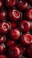 Fresh red cherries in syrup close-up macro shot showing glossy texture and natural fruit patterns for culinary and food photography projects.
