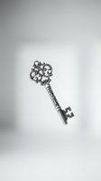 Ornate vintage silver key with decorative scrollwork and intricate baroque design isolated on white background for antique and luxury concepts.