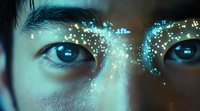 Close up of Asian eyes with glowing turquoise sparkles and magical light effects across eyebrows, creating mystical beauty and ethereal atmosphere in blue tones.