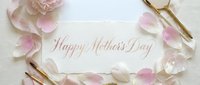 Happy Mother's Day greeting card with pink rose petals and gold pen on white background. Elegant feminine design for celebrating motherhood and family love.