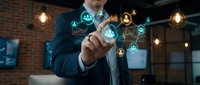 Professional businessman touching digital network interface with glowing icons representing connectivity and technology solutions in modern office.