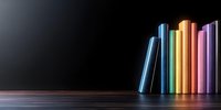 Colorful books arranged in rainbow order standing on wooden surface against dark background, creating minimalist composition for education concepts.
