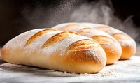 Fresh baked bread loaves with steam and flour dust on rustic wooden surface, golden brown crust and artisanal shape, food photography.