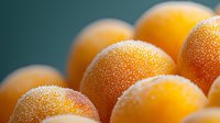 Fresh ripe kumquats covered in morning dew drops close up macro shot on dark background, natural organic citrus fruits with water droplets.