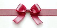 Pink satin ribbon bow isolated on white background for gift wrapping, decoration and craft projects.