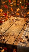 Wooden table surface with scattered autumn leaves and warm sunlight, ideal for seasonal marketing and fall-themed designs.