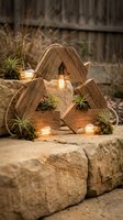 Rustic wooden recycle symbol decorated with Edison bulbs, air plants, and moss, placed on stone surface outdoors, blending sustainability and nature decor.
