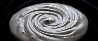 Creamy white swirl with glossy texture on dark background, suitable for cosmetics, skincare product packaging, and design overlays.