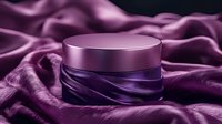 Luxury cosmetic cream jar on purple silk fabric background with elegant folds and reflective surface, showcasing premium skincare product presentation.