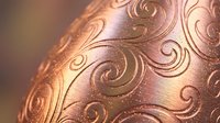 Elegant copper ornament with intricate swirl patterns and metallic finish for luxury holiday decorations and festive seasonal design projects.