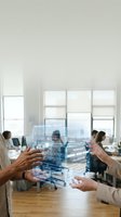 Business professionals analyzing holographic data visualization interface in modern office environment for corporate strategy and digital transformation.