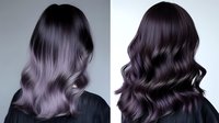 Luxurious dark purple to silver ombre hair with soft waves shown from back view, demonstrating professional hair coloring and styling technique for modern salon inspiration.