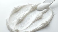 Creamy white cosmetic product with brush strokes isolated on white background, ready for skincare, beauty, and wellness design applications.