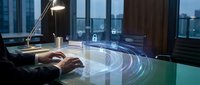 Professional businessman working on futuristic holographic interface with digital security icons in modern office environment at dusk.