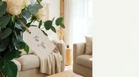 Cozy living room interior with eucalyptus bouquet, gift tag, beige sofa and warm natural lighting for home decor and lifestyle content.