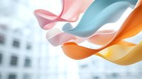 Flowing colorful silk ribbons in pastel pink, blue, orange and yellow creating graceful curves and waves against soft blurred background. Elegant abstract design.