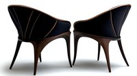 Modern curved armchairs with black upholstery and wooden legs on white background, elegant furniture design for contemporary interior spaces.