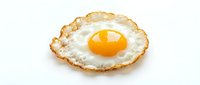 Crispy fried egg with golden yolk and lacy edges isolated on white background for breakfast menu design and culinary projects.