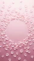 Delicate pink rose petals scattered on soft pink gradient background creating romantic frame with empty center space for text or design elements.