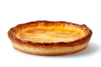 Freshly baked homemade custard tart with caramelized top and flaky pastry crust on white background, traditional French dessert cuisine.