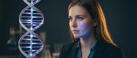 Young female scientist examining DNA double helix structure in modern laboratory with blue lighting for genetic research and biotechnology studies.