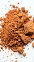 Cocoa powder and chunks scattered on white surface, suitable for baking, culinary, and food photography projects.