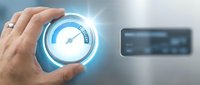 Male hand holding glowing speedometer gauge with blue light effect, representing performance metrics, speed optimization, and digital technology solutions for business applications.