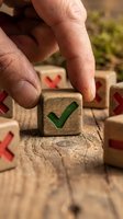 Hand selecting wooden cube with green checkmark symbol from collection of blocks with red X marks on rustic wood surface for decision making concepts.