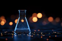 Laboratory glass flask with sparkling liquid against dark background with glowing bokeh lights creating magical scientific atmosphere.
