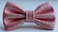Elegant pink glittery bow tie with sparkly texture isolated on white background for formal wear fashion accessories and special occasion styling.